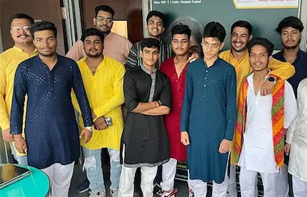 English course students posing in colorful ethnic attire, smiling together and celebrating culture