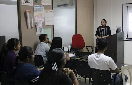 Trainer teaches in a smart classroom while students listen attentively