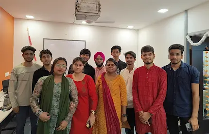 Students pose happily for a group photo after their english class