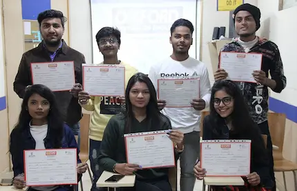 Students proudly show certificates after completing their english course