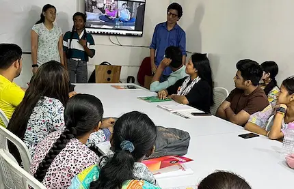 Students perform a fun english roleplay as classmates and trainer watch