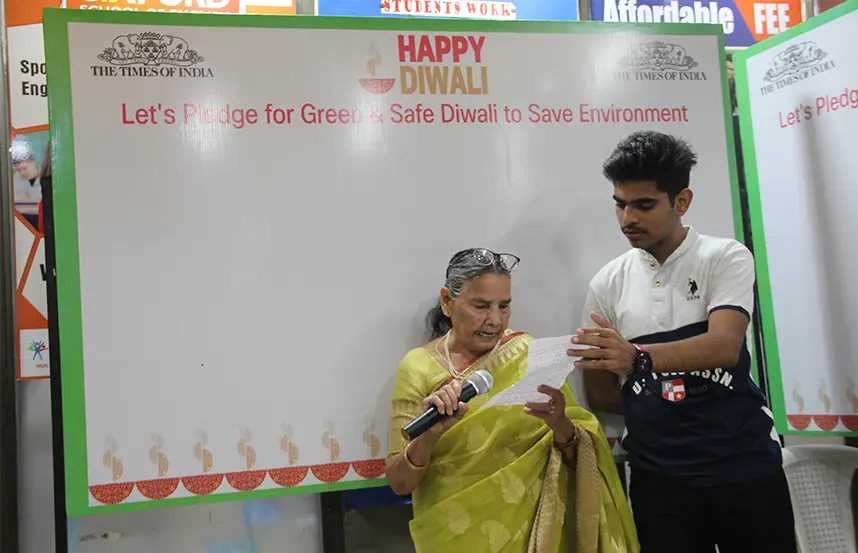 A senior spoken English student reading aloud in class while holding a mic with confidence.