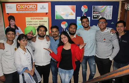 Students pose joyfully at the english center, celebrating their progress